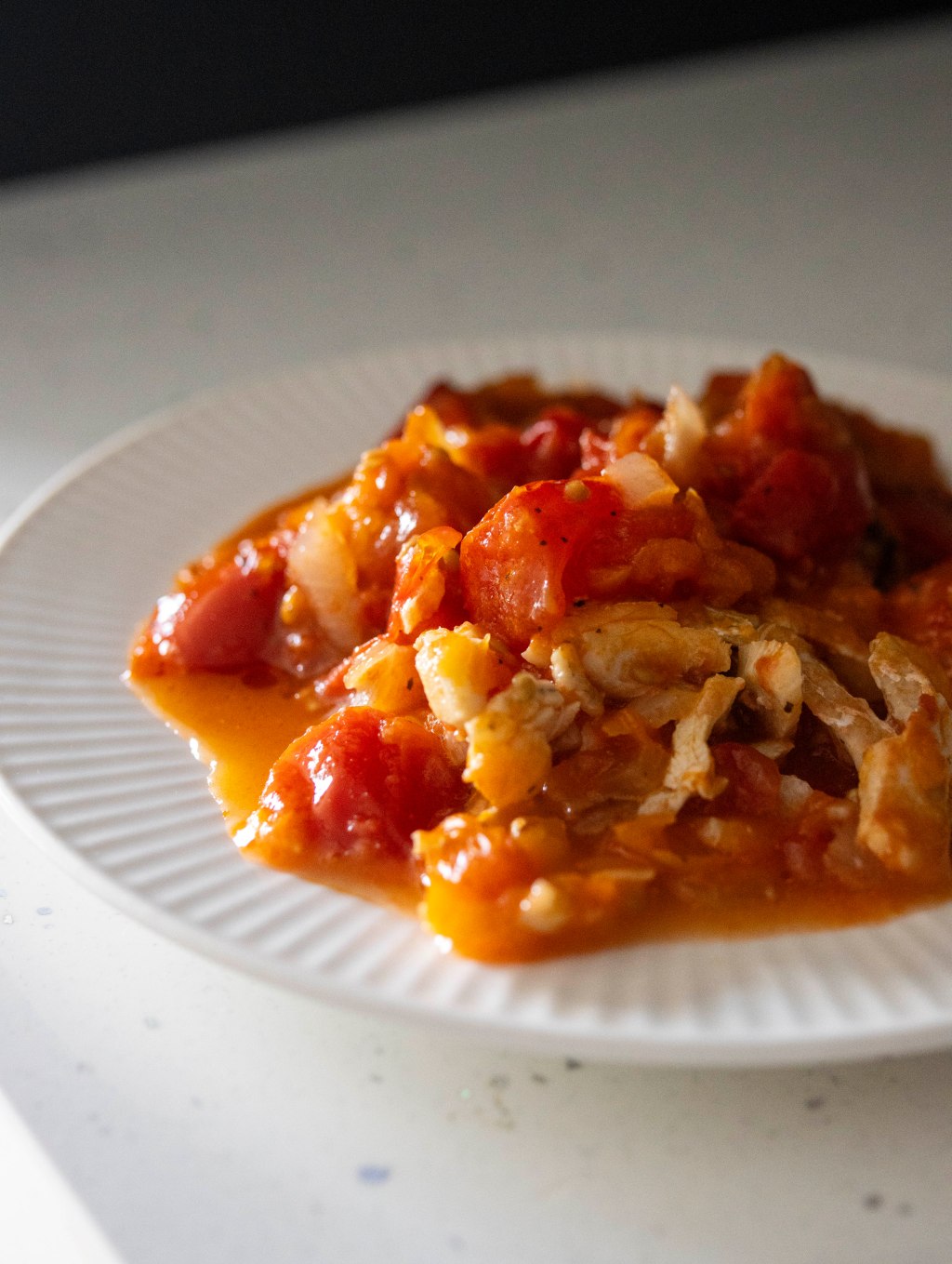Dish with tomato stew and white fish